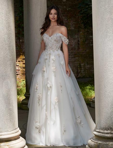 Model wearing a wedding dress in between large white pillars