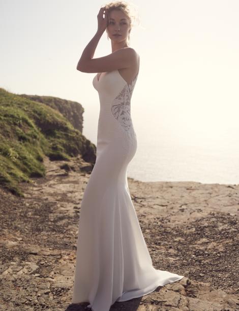 PIttsburgh bride modeling her wedding dress near the ocean