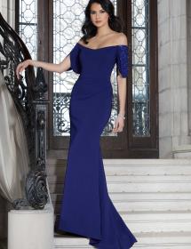 MGNY mothers dress style 72613 being modeled by a mother on a staircase in front of an opulent house entrance.