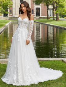 Woman in bridal gown in front of a small rectangular pond